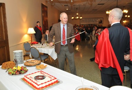 Colonel Gordon Batcheller, USMC, Ret. prepares to cut the Birthday Cake
