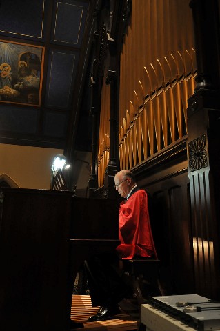 Mr. Philip Calder masterfully plays the organ during the Mass