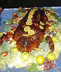Dinner's main dish was a 159-pound pig, brought out on a richly decorated platter.