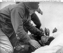 Fr. Joseph O’Callahan ministers to an injured man aboard the USS Franklin, March, 1945