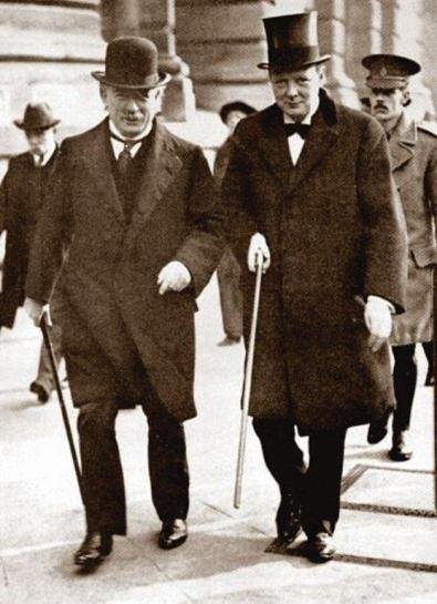 Churchill in top hat walking with Champberlain The Hat