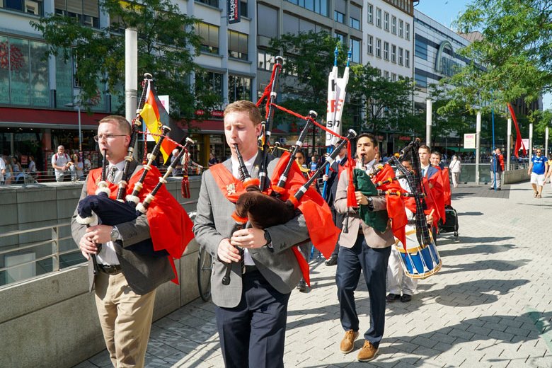 TFP Caravan band with bagpipes and drums marched down the streets