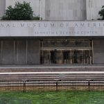 Facade of the National Museum of American History (Kenneth Behring Center) with steps and a two-jet fountain in front of a reflecting pool.